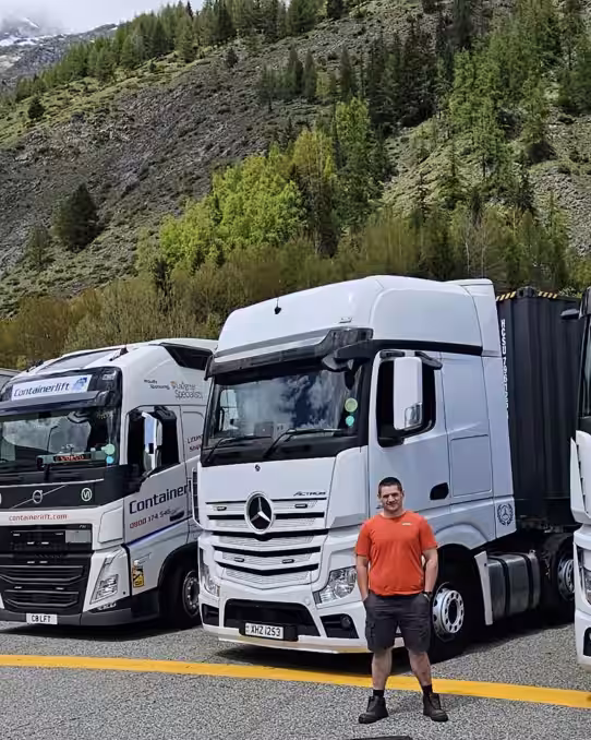Image of Geoff stoof in front of white HGV's used in transport training