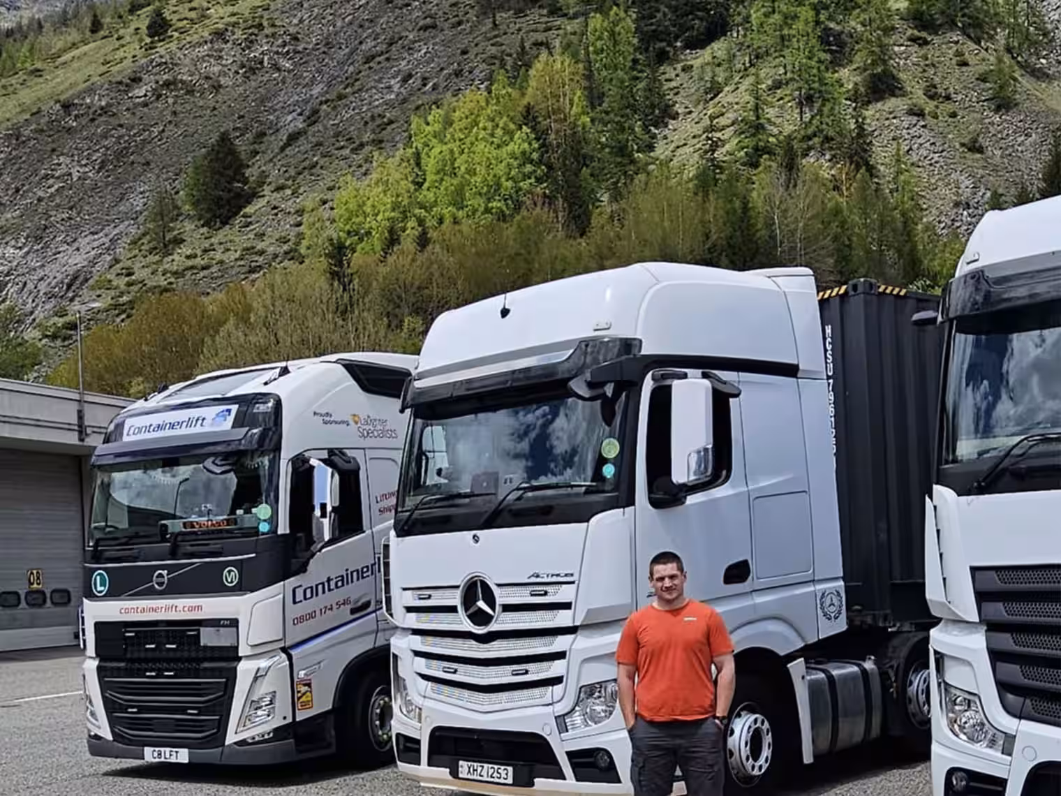 Image of Geoff stoof in front of white HGV's used in transport training