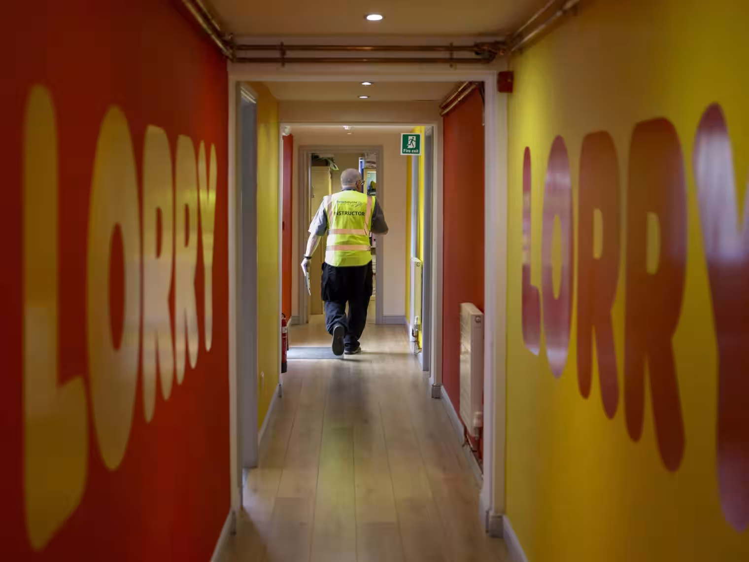 Image of someone in high vis clothing walking through corridoor at the Lifft headquarters