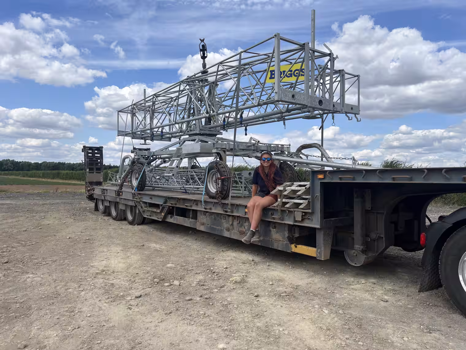 Image of HGV trainee sat on large trailer with metal truss structure