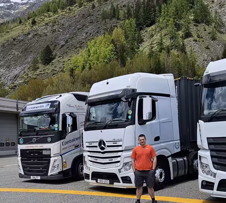 Image of Geoff stoof in front of white HGV's used in transport training